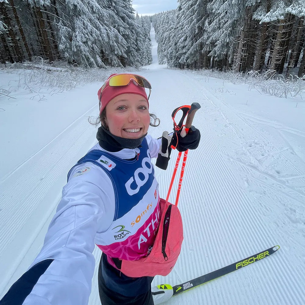 Julie Pierrel, fondeuse, en séance de ski de fond avec bâtons Guidetti en forêt enneigée